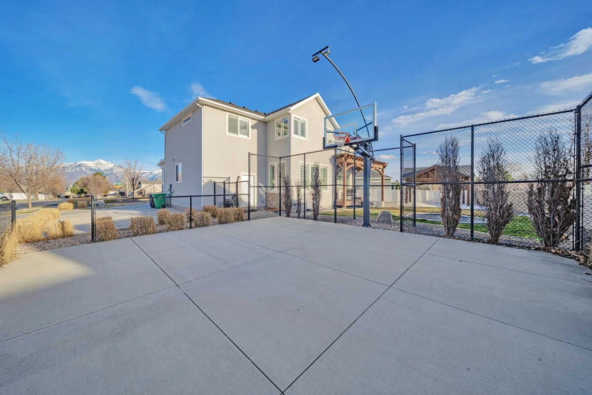 Private half basketball court beside the backyard