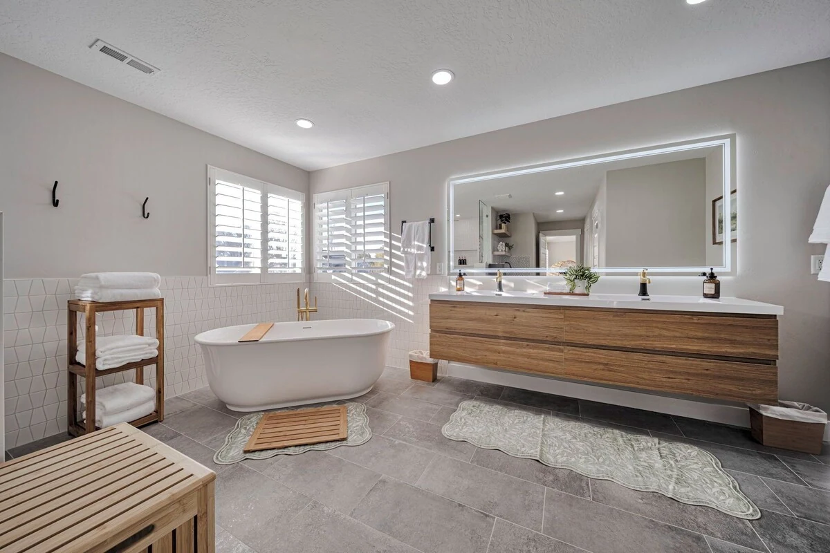 Upstairs primary bathroom with a freestanding soaking tub and double vanity
